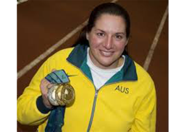 Photo of Louise Sauvage holding gold medals